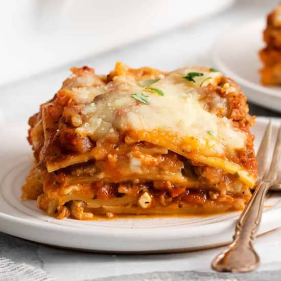 Lasagna on a plate with a fork.