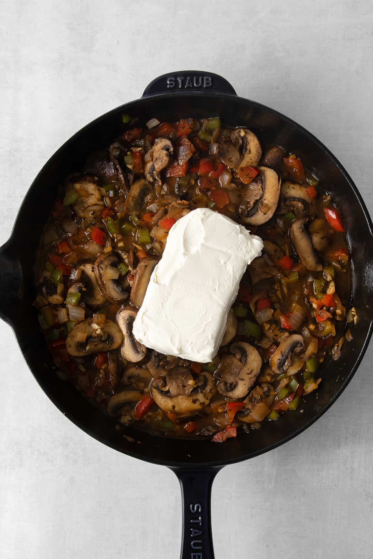 Veggies in a skillet with cream cheese.