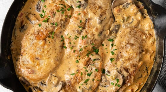 a skillet filled with chicken and mushrooms in a creamy sauce.