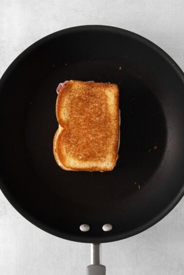 a piece of toasted bread in a frying pan.