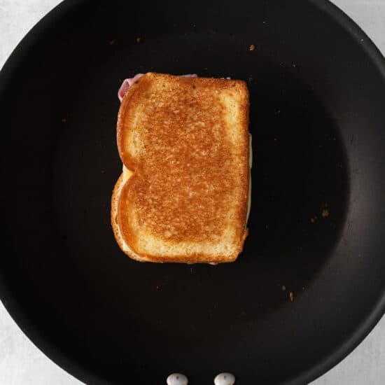 a piece of toasted bread in a frying pan.