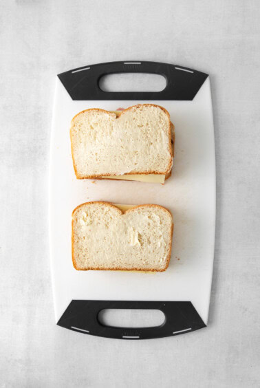two slices of bread on a cutting board.