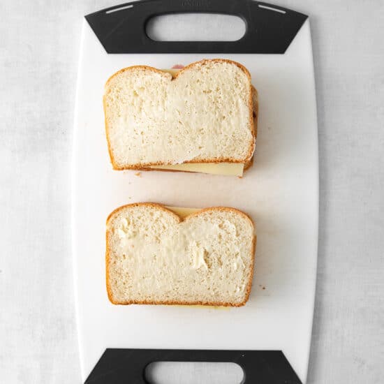 two slices of bread on a cutting board.
