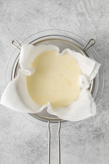 melted butter in a pan on a gray background.