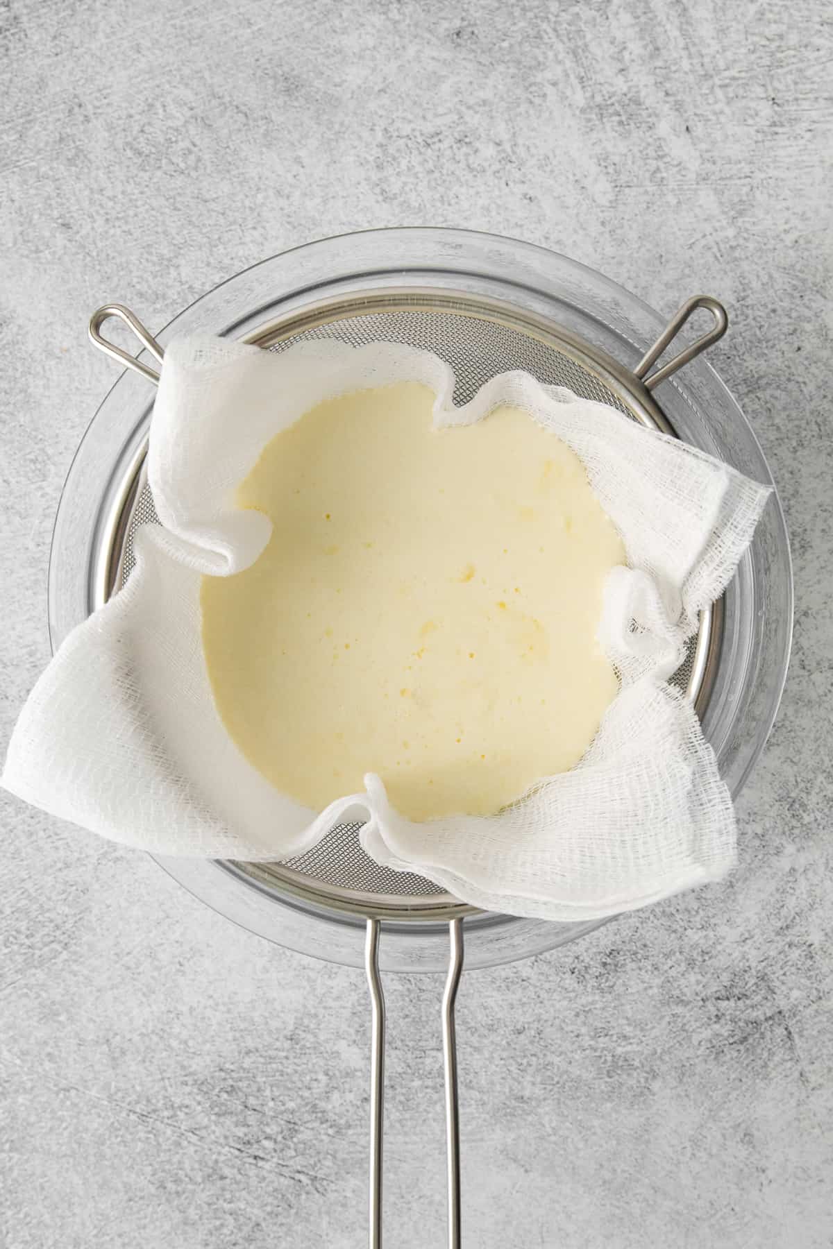 Mascarpone cheese in a cheesecloth.