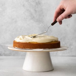 a person cutting a cake with a fork.