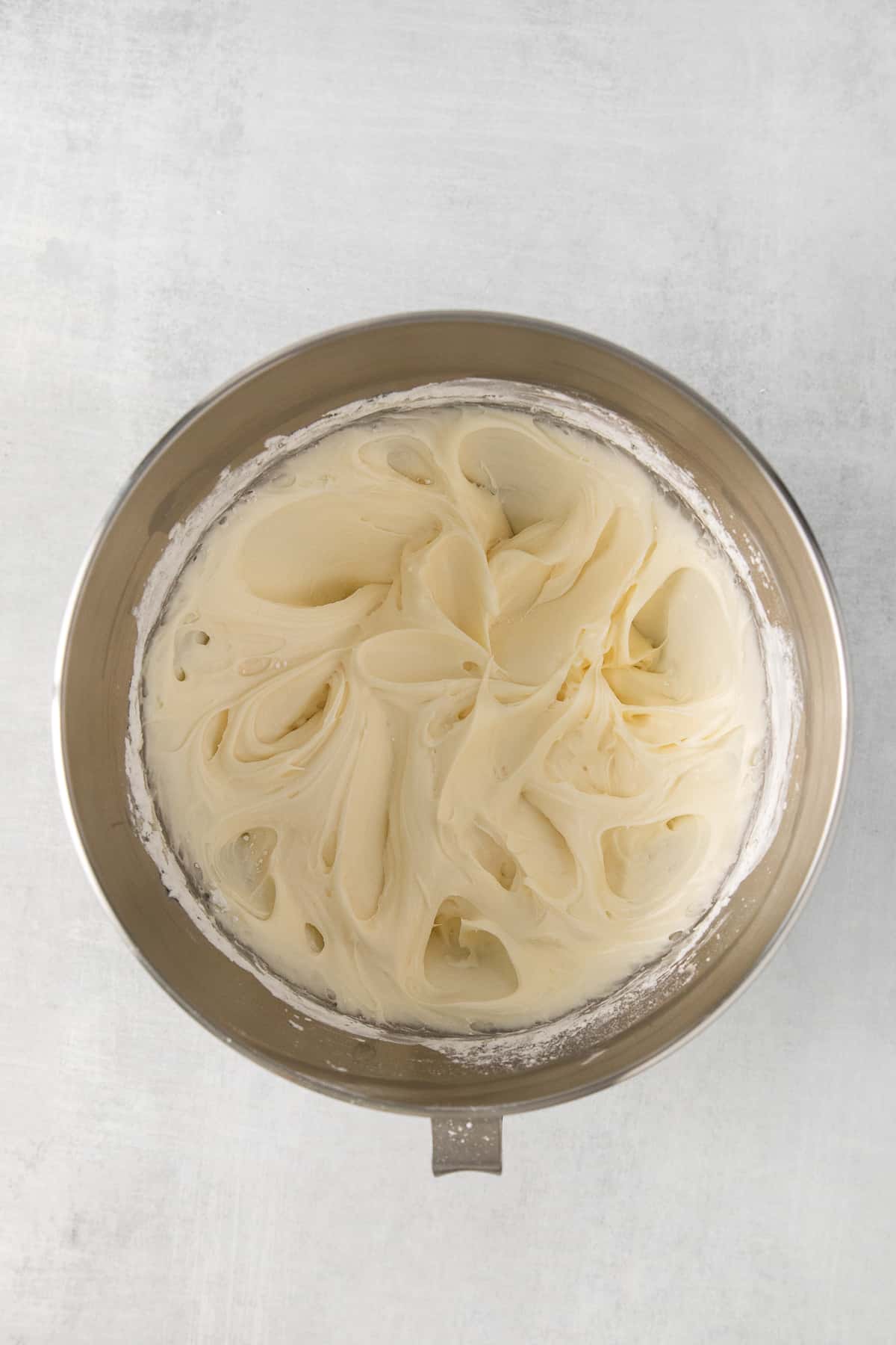 Mascarpone frosting in a mixing bowl.
