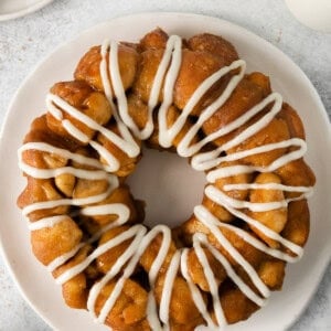 a cinnamon bun with icing on a plate.