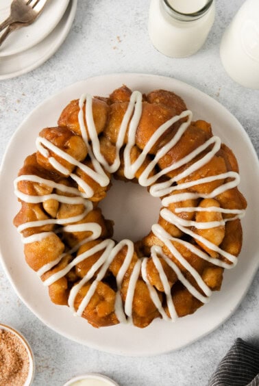 a cinnamon bun with icing on a plate.