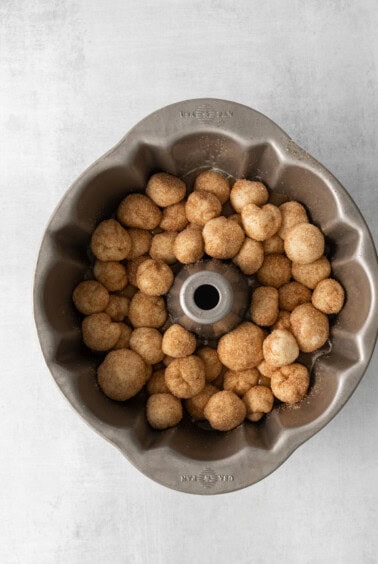 a metal bundt pan filled with doughnuts.
