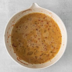 a bowl of soup on a white surface.