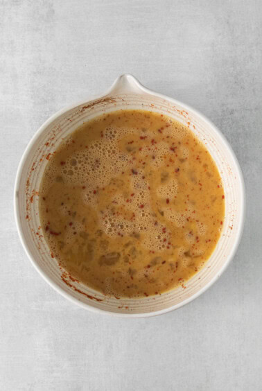 a bowl of soup on a white surface.