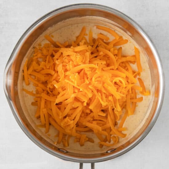 shredded cheese in a pan on a white background.