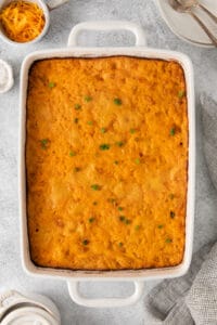 cheesy tater tot casserole in a white dish.