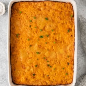 cheesy tater tot casserole in a white dish.