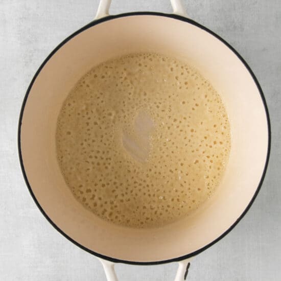 a pot filled with liquid on a white background.