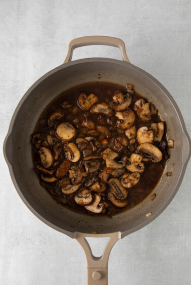 mushroom gravy in a skillet on a white background.