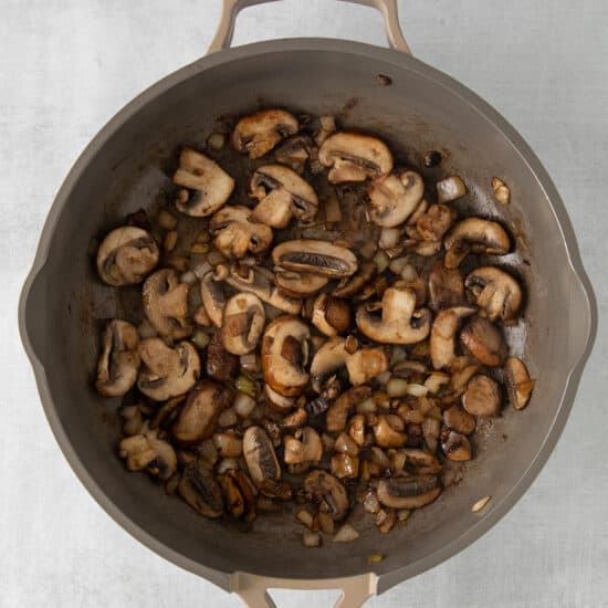 mushrooms in a skillet on a white background.