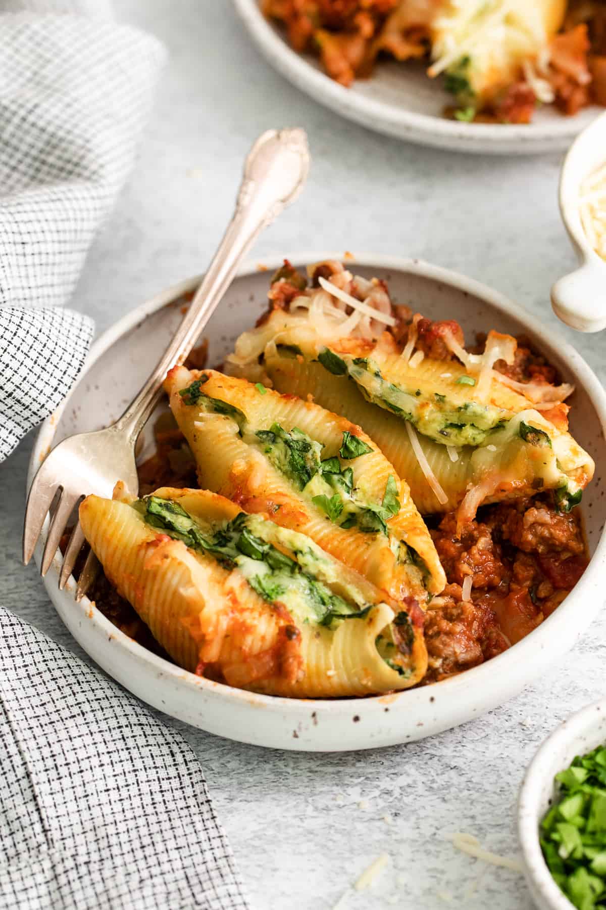 Stuffed shells with meat sauce on a plate.