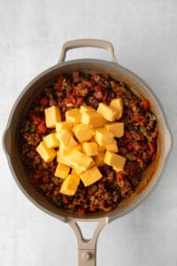 a skillet filled with meat and cheese.