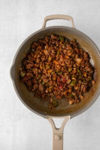 a skillet filled with meat and vegetables.