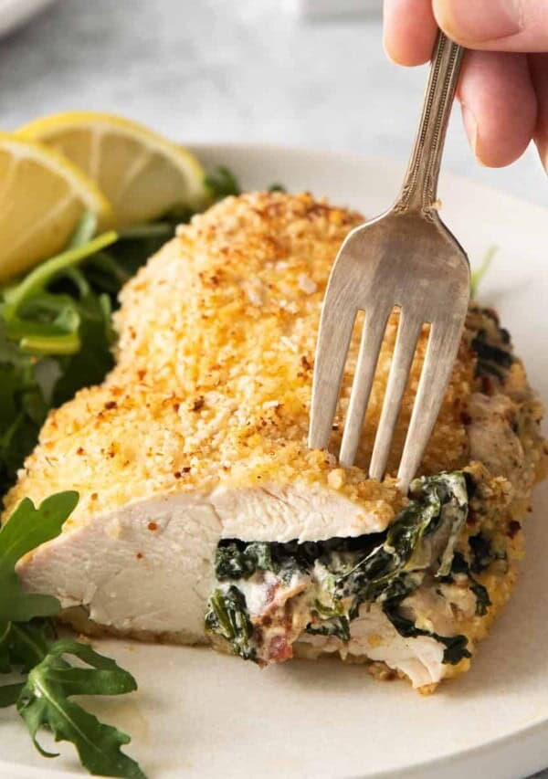 Cream cheese stuffed chicken on a plate.