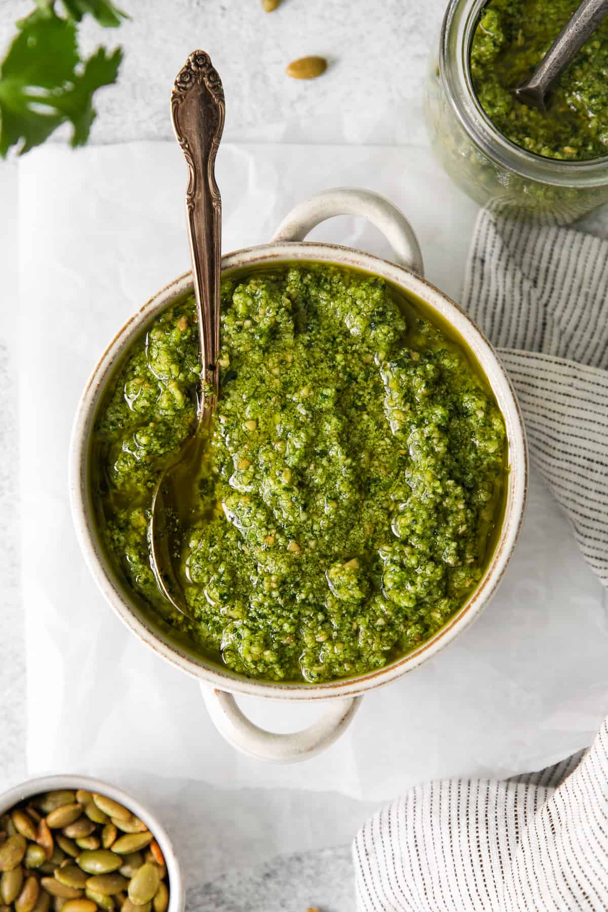 Cilantro pesto in a bowl with a spoon.