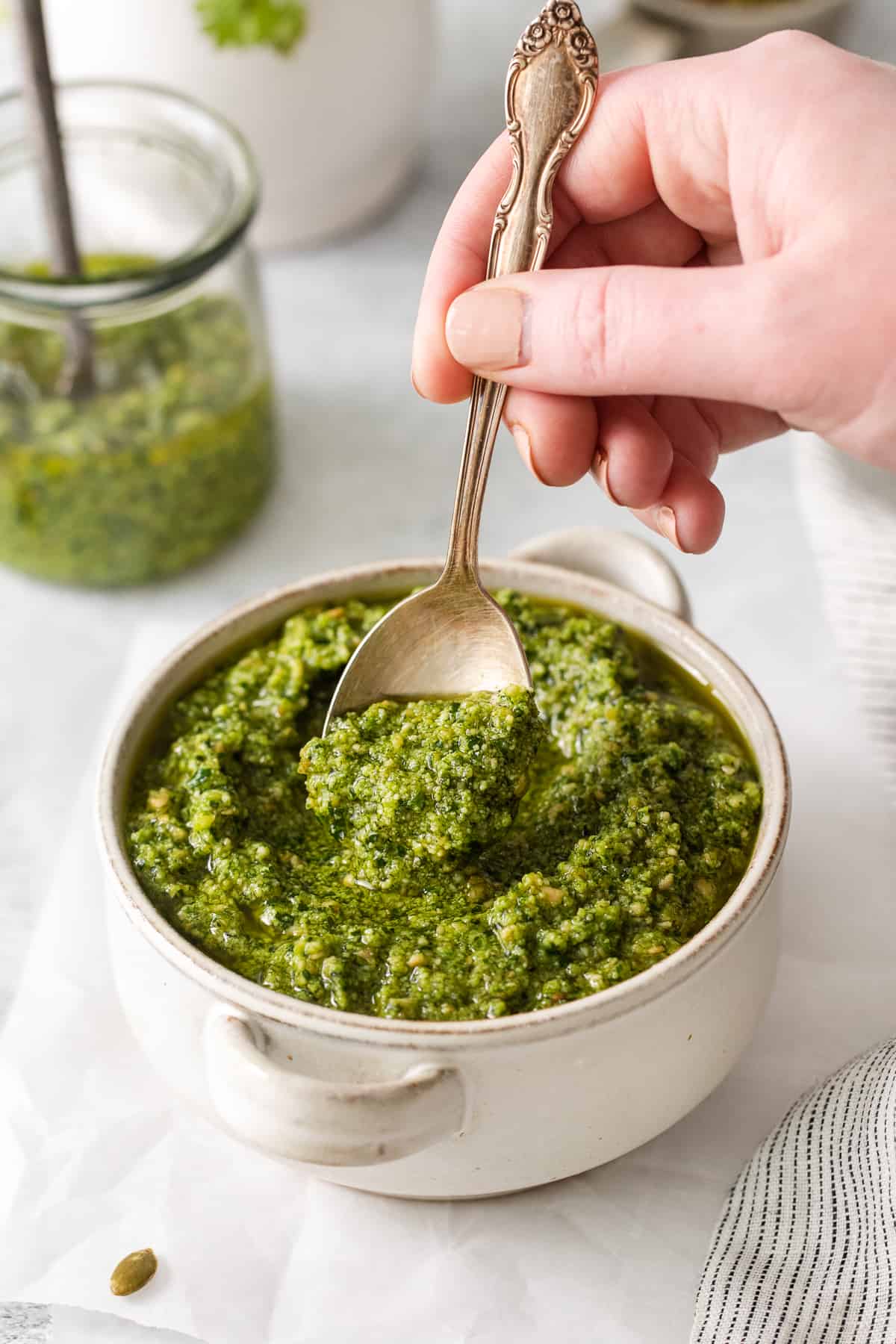 Cilantro pesto in a bowl with a spoon.