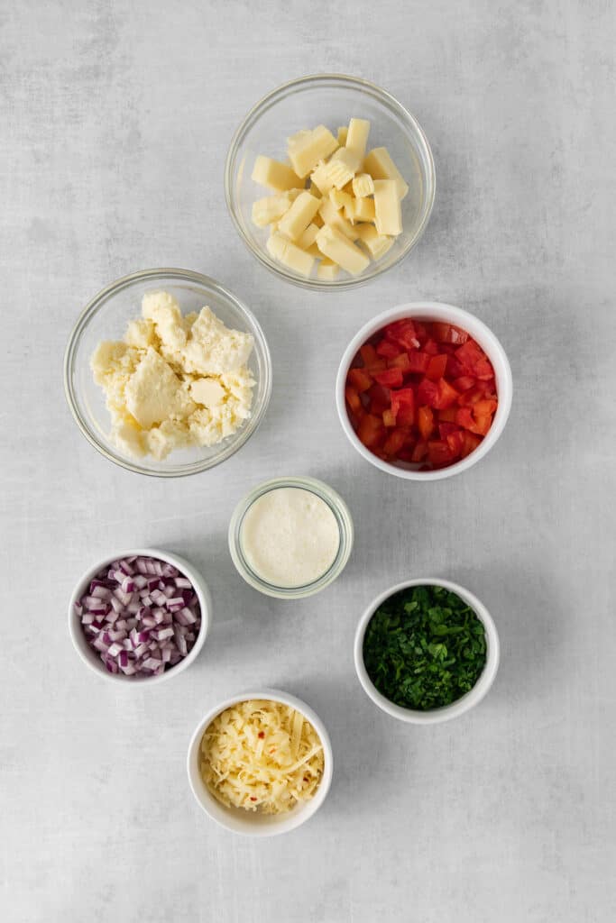 Ingredients for cotija queso dip in bowls.