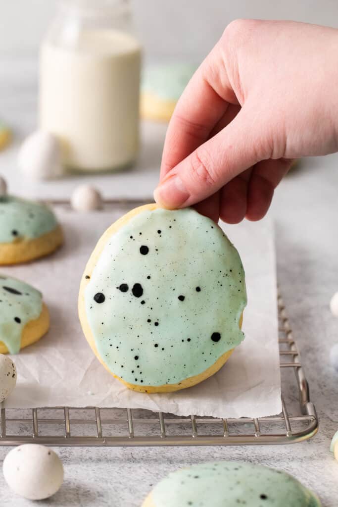 Lemon ricotta cookie being held up by a hand.