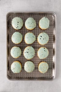 cookies on a cooling rack with blue sprinkles.