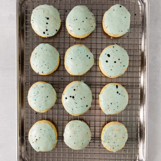 cookies on a cooling rack with blue sprinkles.