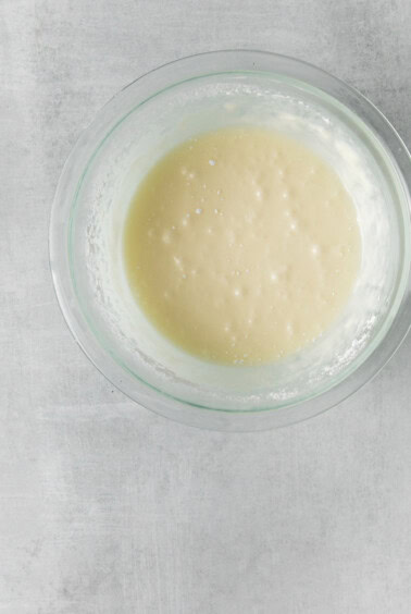 a glass bowl with a mixture in it.