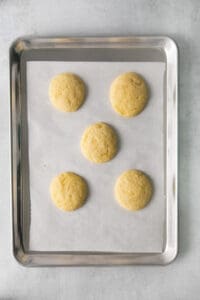 four cookies on a baking sheet.