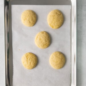 four cookies on a baking sheet.