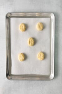 four cookies on a baking sheet.
