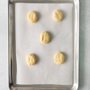 four cookies on a baking sheet.