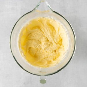 a glass bowl filled with yellow batter.