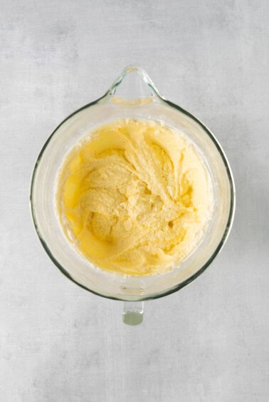 a glass bowl filled with yellow batter.