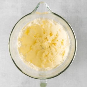 butter in a glass bowl on a gray background.