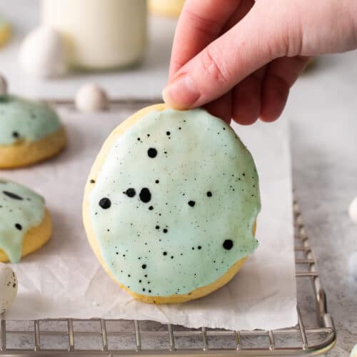 Lemon ricotta cookie being held up by a hand.