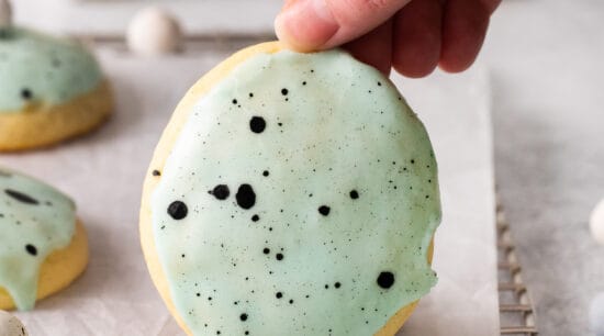 Lemon ricotta cookie being held up by a hand.