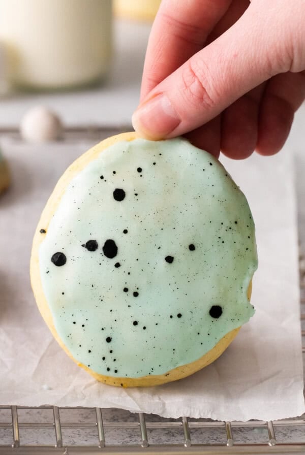 Lemon ricotta cookie being held up by a hand.