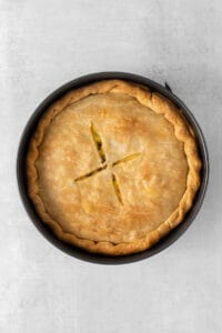 a pie in a pan on a grey background.