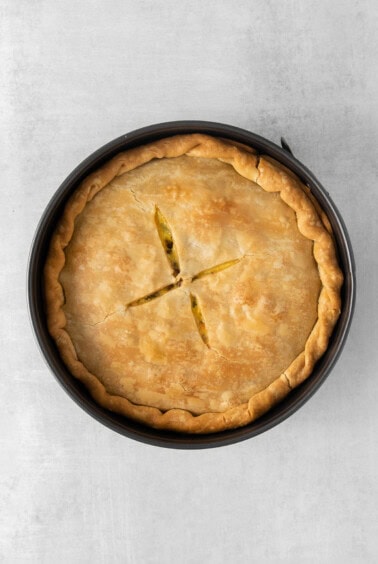 a pie in a pan on a grey background.