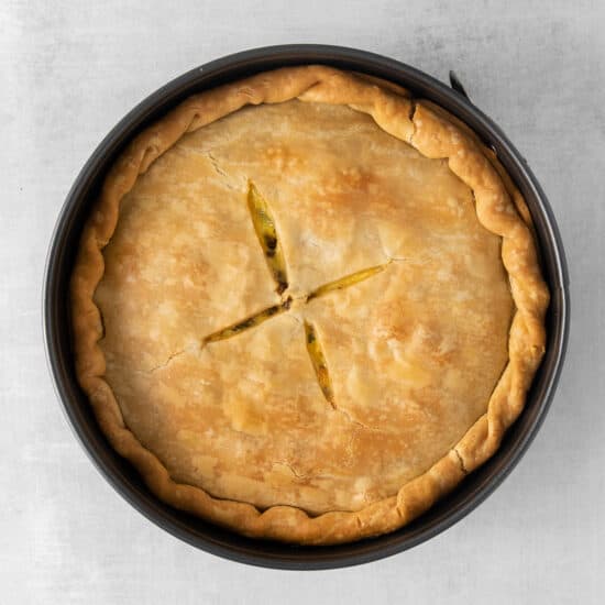 a pie in a pan on a grey background.