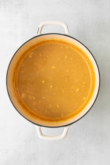 a pot of soup on a white background.