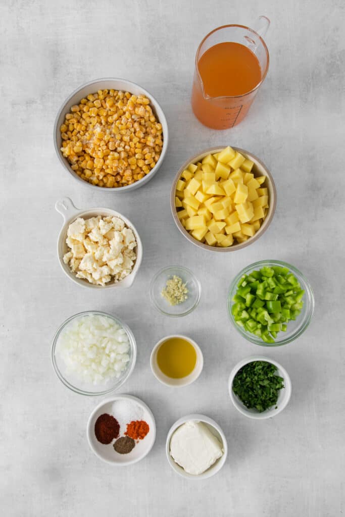 Ingredients for Mexican street corn soup in bowls.