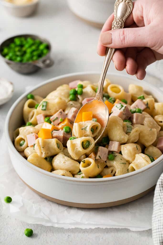 Ham and pea pasta salad on a spoon.