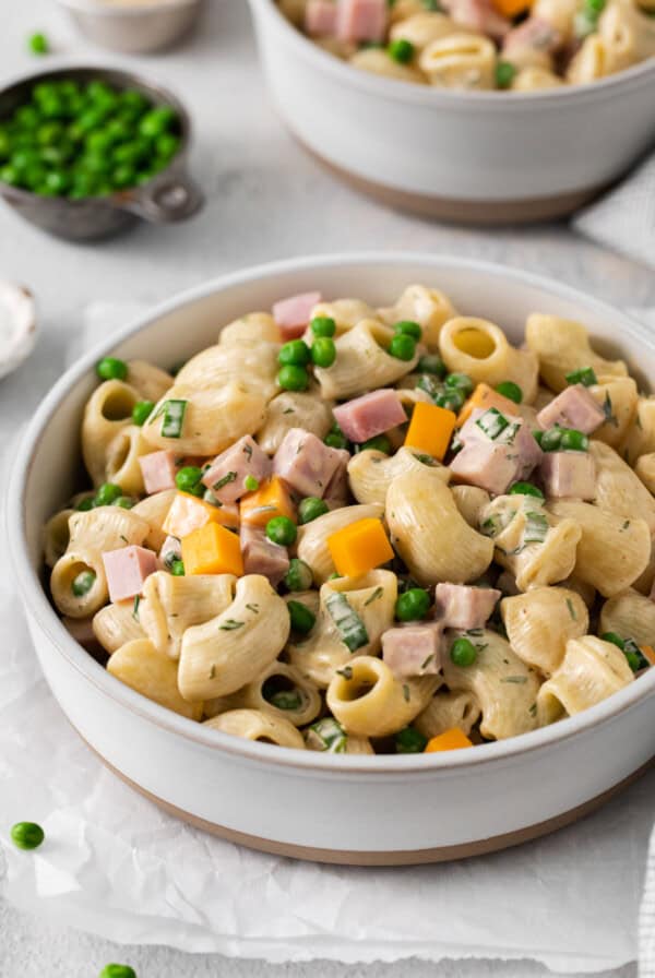 Ham and pea pasta salad in a bowl.